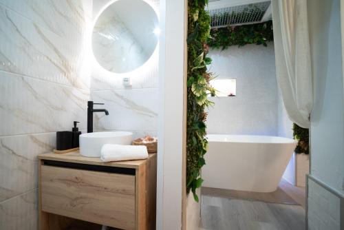 a bathroom with a white tub and a sink at Luxer Holidays in Málaga
