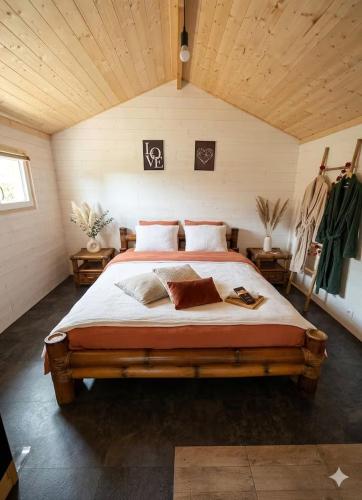 a bedroom with a large bed in a attic at Cabanoù Lodge & Spa in Messanges