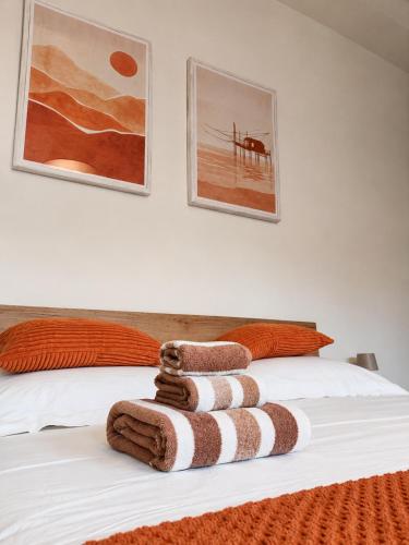 a bed with a pile of towels on it at Orizzonti in Ortona