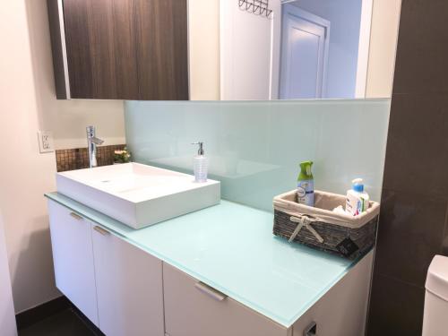 a bathroom with a sink and a mirror at Central City Suites with Free Parking in Toronto