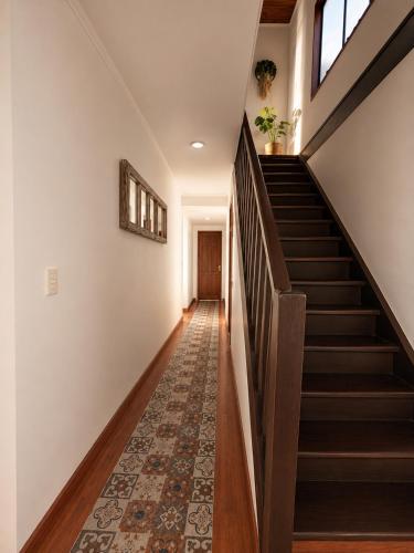 a staircase in a house with a rug at Casa Vista Pacífico in Concón