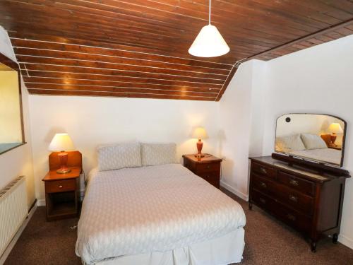 a bedroom with a bed and a large mirror at Teach Feirme in Clonakilty