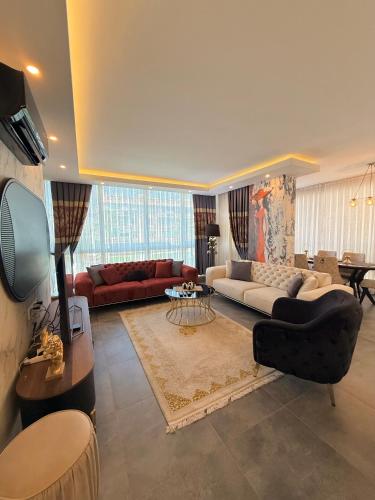 a living room with a couch and a tv at SA Apartments! 2BR Flat 100m to Cleopatra Beach in Alanya