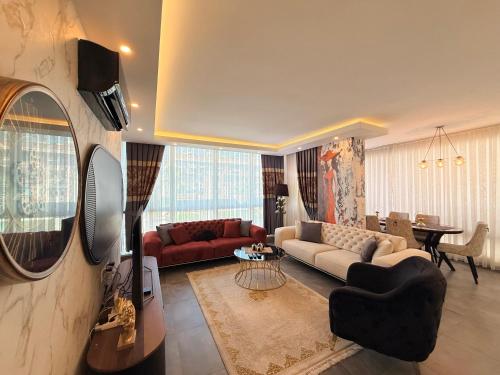 a living room with a couch and a table at SA Apartments! 2BR Flat 100m to Cleopatra Beach in Alanya