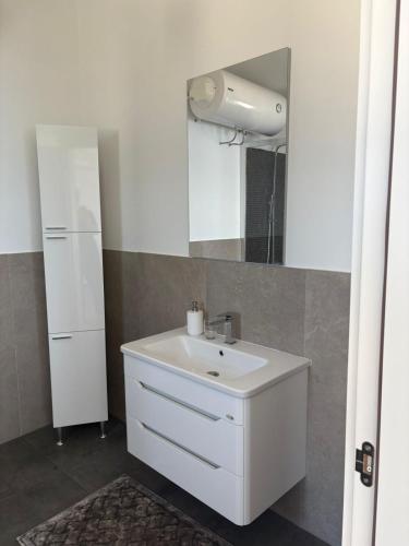 a bathroom with a white sink and a mirror at Haus am Strand in Bar