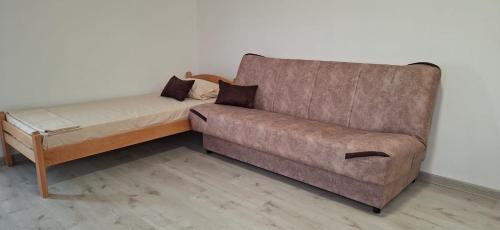 a couch and a chair in a room at JMM Apartment in Kotor