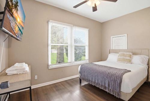 a bedroom with a bed and a window at Group-Ready 6BR Gem in Central Lafayette in Lafayette