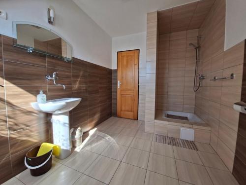 a bathroom with a sink and a shower at Pension Chalupka l with a panoramic view of Spiš Castle in Spišské Podhradie