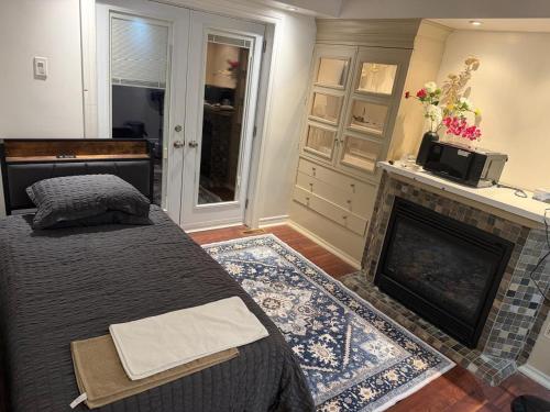 a bedroom with a bed and a fireplace at Your own home in Toronto