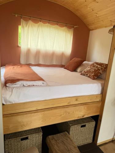 a bedroom with a large bed with a window at Chambre Panoramique Bellevue in Bellegarde-Adoulins