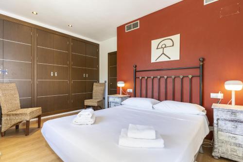 a bedroom with a large bed and two chairs at Sunny Holidays Mojácar Pool House in Mojácar