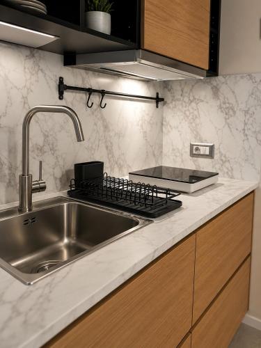 a kitchen with a sink and a counter top at ES Apartments in Nago-Torbole