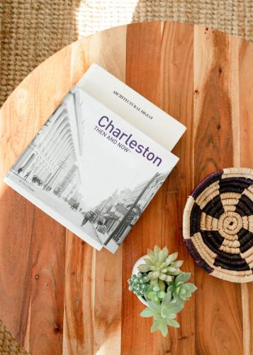 a book sitting on top of a wooden table at Marshfront 5BD Oasis Pool Yard & Steps to Beach in Folly Beach