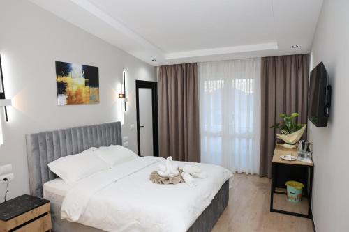 a bedroom with a bed with a cat on it at Kremelo Hotel in Berat