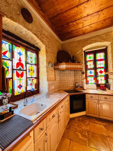 a kitchen with a sink and stained glass windows at Byzantino Omodos House in Omodos