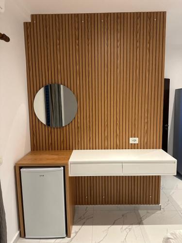 a wooden wall with a mirror and a sink at The Darling Guesthouse in Himare