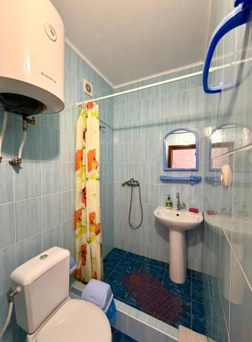 a bathroom with a toilet and a sink at Hotel Elion in Zatoka