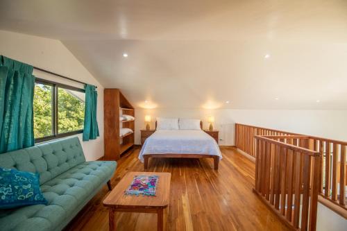 a bedroom with a bed and a couch at Area 101 in Playa Pelada