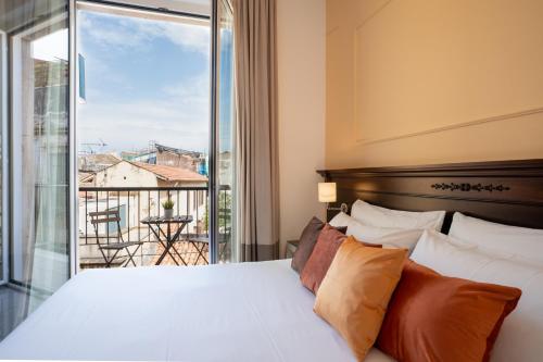 a bedroom with a bed and a large window at Ad Maiora Elegant Rooms in Palermo