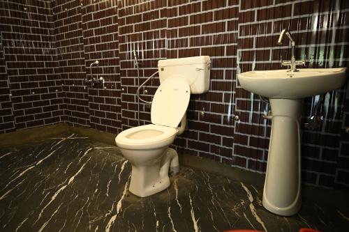 a bathroom with a toilet and a sink at starry nights stay in Batakūt