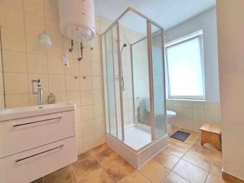 a bathroom with a shower and a sink at Apartament Gruba Foka in Hel