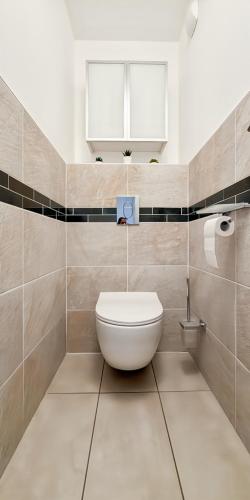 a bathroom with a toilet and a window at Le Balzac - 2 Chambres - Balcon in Tours