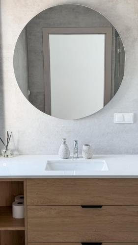 a bathroom with a sink and a mirror at Koło Wody - dom dla 6 osób in Sadków