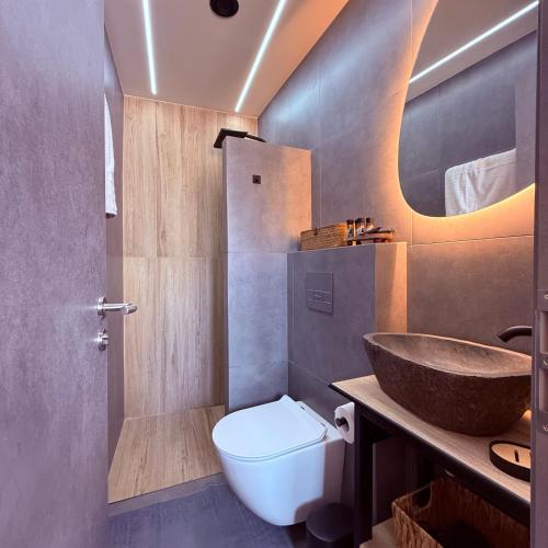 a bathroom with a sink and a toilet and a sink at LemonTreesHouses 1 Peaceful Stay Near Athens Airport & Rafina Port in Pikérmion