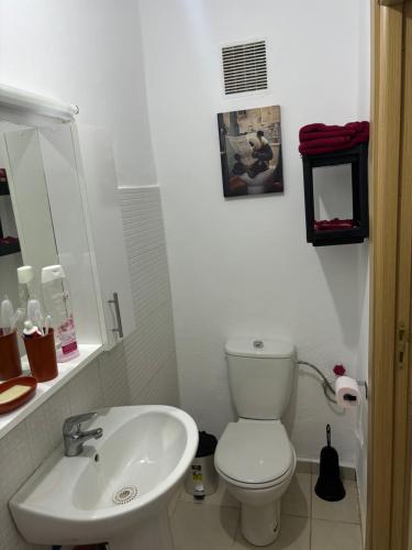 a bathroom with a white toilet and a sink at Résidence Calme Fnideq in Fnidek