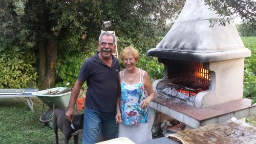 a man and a woman standing in front of a fireplace at B&B Prisca in San Pietro in Campiano