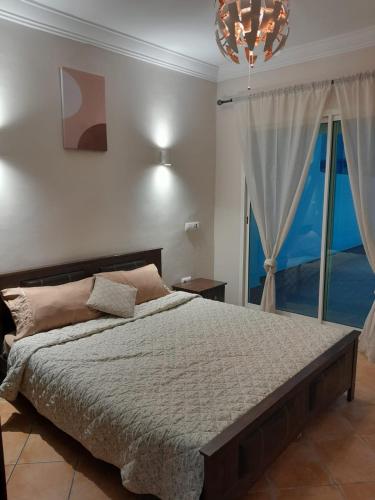 a bedroom with a bed and a large window at Riviera Beach in Cabo Negro