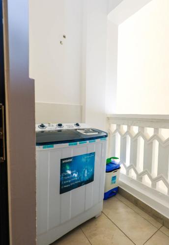 a small white stove in a corner of a room at Chui de eagle in Mombasa