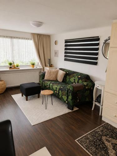 a living room with a couch and a table at RB&B in the NOP in Bant