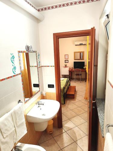 a bathroom with a sink and a mirror at B&B Profumo di Zagara in Taormina