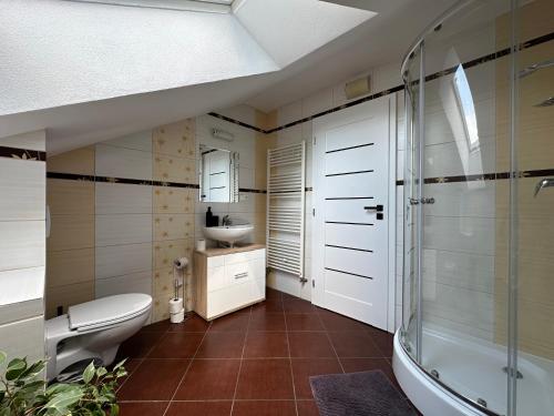 a bathroom with a toilet and a sink at Above Apartments in Liptovský Mikuláš
