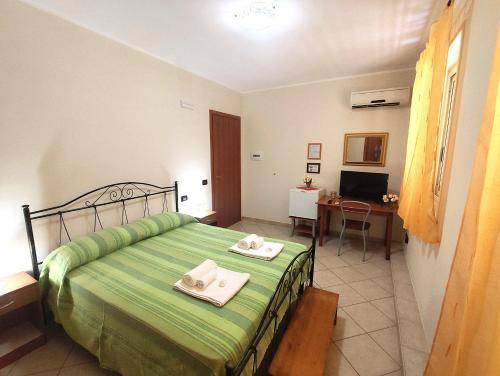 a bedroom with a bed with two towels on it at B&B Profumo di Zagara in Taormina