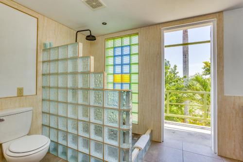 a bathroom with a toilet and stained glass windows at Hill Garden Boutique Resort in San Ignacio