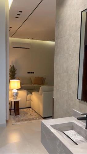 a living room with a couch and a table at شقة غادة الفندقية الفاخرة in Abha