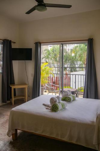 a bedroom with a bed with a large window at Patio Canarias Chacala Suites Pet-Friendly in Chacala