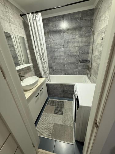 a bathroom with a toilet and a sink and a tub at Квартира в центре города in Komrat