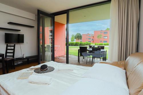 a bedroom with a bed and a view of a patio at Balino C1 in Balatonlelle