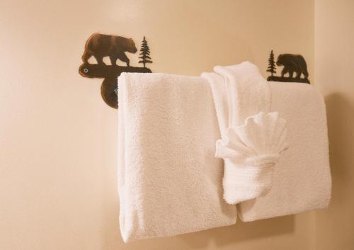 a towel rack with two towels and animals on it at Alpine Lodge Resort in Branson