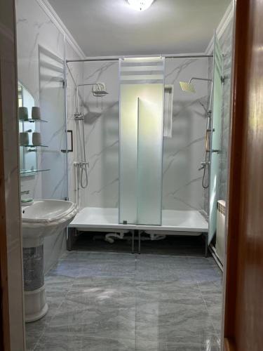 a bathroom with a shower and a sink at Aigul Hostel in Shymkent