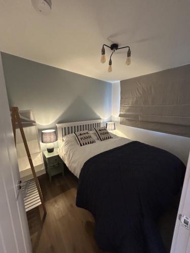 a bedroom with a large bed with a black blanket at SeaStar Dartmouth in Dartmouth