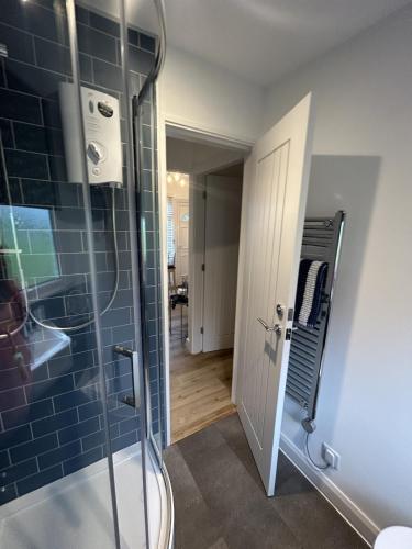 a bathroom with a shower with a glass door at SeaStar Dartmouth in Dartmouth