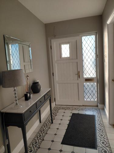 a room with a table and a mirror and a door at Turnpike Mews in Birr