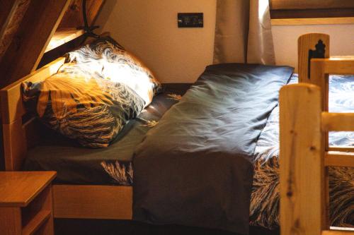 a bed in a dorm room with a bedsheet at Poscenje in Šavnik