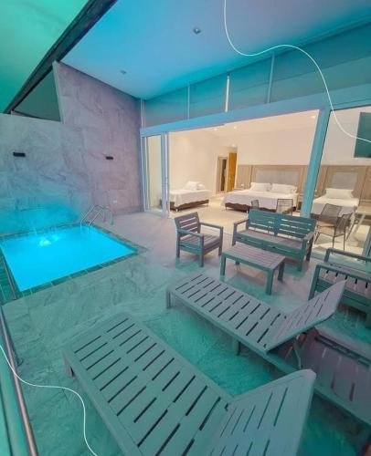 a swimming pool with chaise lounges and a swimming pool at Finca Hotel la Manuela in Armenia