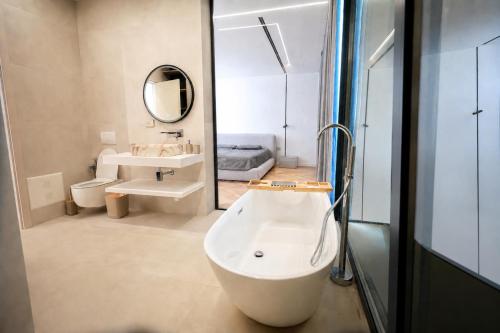 a bathroom with a tub and a sink and a mirror at Hilltop Villa Tirana in Mjull-Bethore