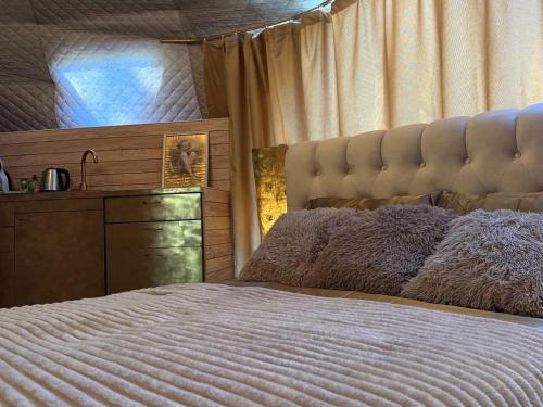 a bedroom with a large bed and a dresser at Couple Luxury Villa in Apšuciems